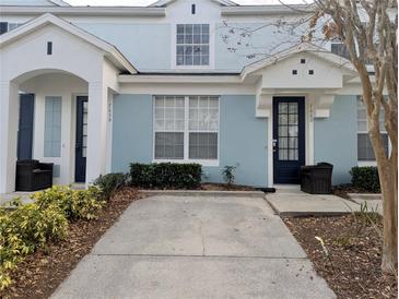 Charming two-story townhomes with light blue exterior paint and well-maintained landscaping at 7660 Otterspool St, Kissimmee, FL 34747