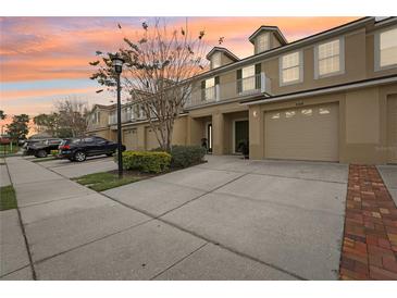 Inviting townhome with well-maintained landscaping, private balconies, and attached garages at 3008 Thornton Dr, Kissimmee, FL 34741