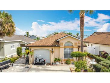 Charming single-story home featuring a well-manicured front yard and an attached one-car garage at 3233 Brewster Dr, Kissimmee, FL 34743