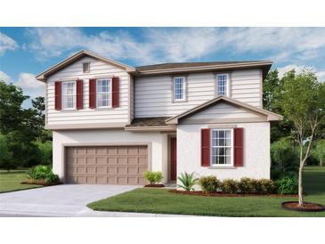 Charming two-story home with a well-manicured lawn, attached garage, and vibrant red shutters at 5453 Catmint Dr, Lake Hamilton, FL 33851