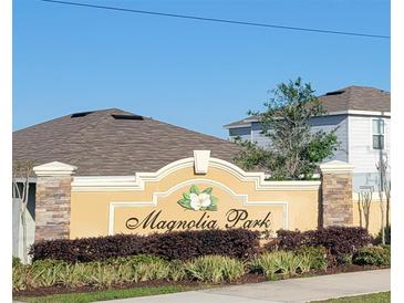 Magnolia Park sign with plants and stone pillars at 676 Tanaro Ln, Haines City, FL 33844