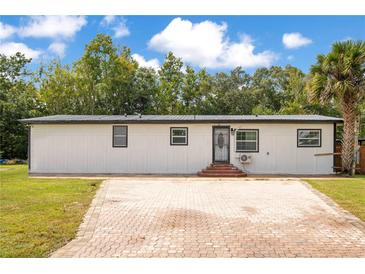 Charming single-story home with a spacious brick driveway and well-maintained landscaping at 78 N 5Th St, Orlando, FL 32833