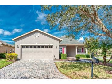 Charming single-story home features a two-car garage and a well-manicured lawn at 153 Ventana Dr, Poinciana, FL 34759