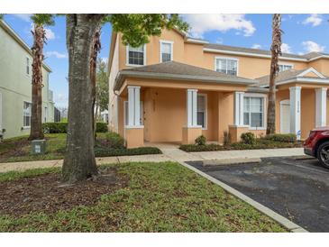 Charming two-story townhome featuring a covered entry and nicely manicured lawn at 1717 Retreat Cir, Clermont, FL 34714