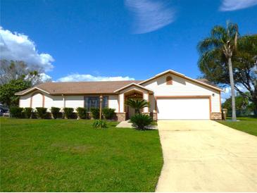 Charming single-story home features a well-maintained lawn and attached two-car garage at 2235 Emperor Dr, Kissimmee, FL 34744