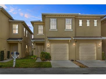 Charming townhome featuring an attached garage and well-maintained front yard at 486 Lake Shore Pkwy, Davenport, FL 33896
