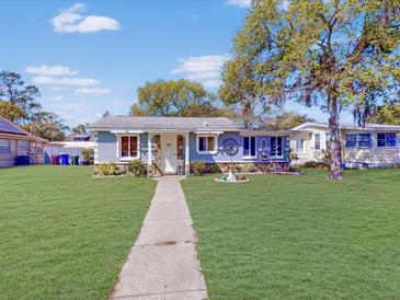 Charming single-story home featuring a well-maintained front yard with a walkway leading to the front door at 1514 Indiana Ave, St Cloud, FL 34769