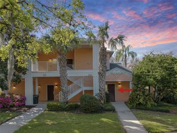 Inviting two-story condo with lush landscaping and charming exterior features at 204 New Providence # 10104, Davenport, FL 33897