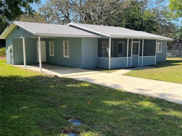 Charming single-story home featuring a screened-in porch, carport, and a well-maintained lawn at 4625 Weston Rd, Bartow, FL 33830
