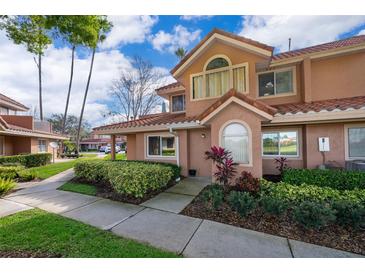 Inviting townhome with a red tile roof and lush landscaping at 8507 Waterview Way, Winter Haven, FL 33884