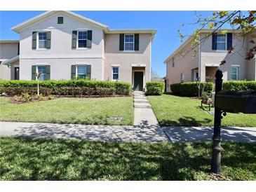 Charming townhome with lush landscaping and a well-manicured lawn welcomes you home at 1615 Reflection Cv, St Cloud, FL 34771