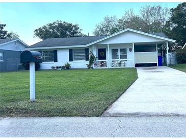 Charming single-story home boasts a well-manicured lawn, a covered porch, and a convenient driveway at 224 Montana Ave, St Cloud, FL 34769