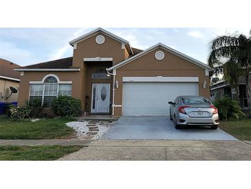 Charming two-story home featuring an attached two-car garage and well-maintained front yard at 2244 Mallard Creek Cir, Kissimmee, FL 34743