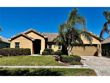 Charming single-story home featuring a tile roof, brick driveway, and well-maintained landscaping at 2981 Winding Trl, Kissimmee, FL 34746