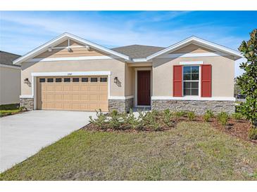 Charming single-Gathering home with a well-manicured lawn and stone accents at 2985 Gavin Sky Dr, Kissimmee, FL 34744