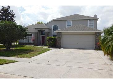 Charming two-story home featuring a spacious driveway and well-maintained landscaping at 409 Lytton Cir, Orlando, FL 32824