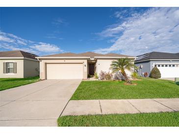 Charming single-story home with well-maintained lawn, mature landscaping, and a two-car garage at 579 Lucerne Blvd, Winter Haven, FL 33881