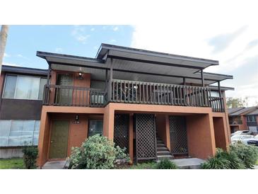 Two-story condo featuring covered balcony, private entrance and muted earth-tone color palette at 1240 Sago Palm Blvd # 1240, Kissimmee, FL 34741