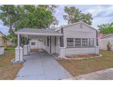Charming home featuring a carport, well-maintained lawn, and classic siding at 406 10Th St, St Cloud, FL 34769