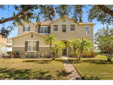 Charming two-story home with lush landscaping and a welcoming walkway at 4061 Flowering Peach Ln, St Cloud, FL 34772