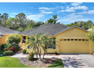 Charming single-story home with well-manicured lawn, beautiful landscaping and a two-car garage at 722 Portofino Dr, Kissimmee, FL 34759