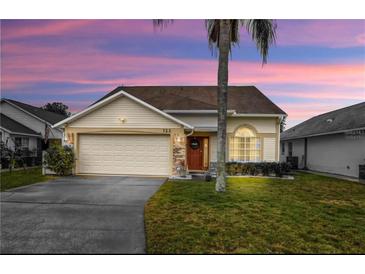 Charming single-story home featuring a two-car garage and well-maintained lawn at 723 Allison Ave, Davenport, FL 33897
