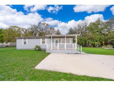 Charming single-story home with a covered front porch and well-maintained lawn at 790 Park Ln, Kissimmee, FL 34741