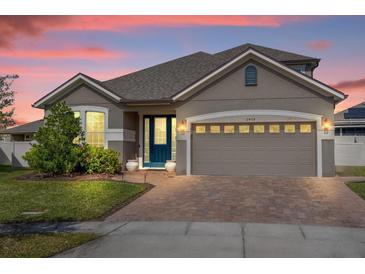 Charming single-Gathering home with a well-maintained lawn and brick driveway, featuring a two-car garage at 2468 Varenna Loop, Kissimmee, FL 34741