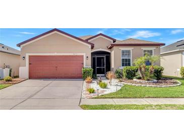 Charming single-story home featuring a well-maintained lawn and an attached two-car garage at 3471 Julius Estates Blvd, Winter Haven, FL 33881
