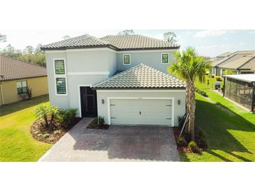Charming two-story home featuring a two-car garage, neutral paint, tile roof, and well-manicured landscaping at 3920 Reed Grass Pl, Kissimmee, FL 34746
