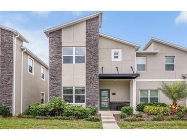 Charming two-story home with stone accents, inviting entrance, and well-maintained landscaping, offering curb appeal at 978 Splash Shot Pl, Davenport, FL 33896