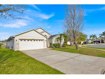 Charming single-Gathering home with a two-car garage and well-maintained landscaping on a sunny day at 1010 Prey Ct, Kissimmee, FL 34746
