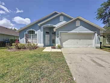 Charming single-story home featuring a well-maintained lawn and a two-car garage at 1361 Rebecca Dr, Haines City, FL 33844