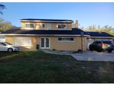 Charming two-story home with well-maintained lawn and a spacious driveway for multiple cars at 2211 New Jersey Rd, Lakeland, FL 33803