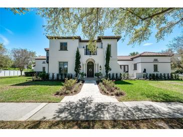 Stunning two-story home with a beautiful front yard, pathway, and architectural details at 808 Golfpark Dr, Celebration, FL 34747