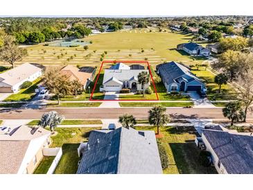 Beautiful home with a two-car garage, surrounded by mature trees and lush landscaping at 16014 Hawk Hill St, Clermont, FL 34714