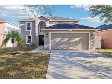 Attractive two-story home with a spacious driveway leading to an attached two-car garage at 16035 Wilkinson Dr, Clermont, FL 34714