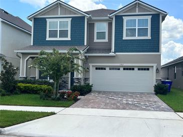 Charming two-story home with a two-car garage, manicured landscaping, and inviting curb appeal at 1767 Smarts Rule St, Kissimmee, FL 34744