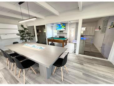 Spacious recreation room with a pool table, large table, and adjacent bar for endless entertainment possibilities at 2326 S Peninsula Dr, Daytona Beach, FL 32118