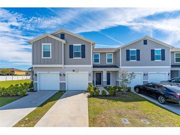 Charming townhome features a well-manicured lawn and inviting front entrances at 1536 Mirabella Cir, Davenport, FL 33897