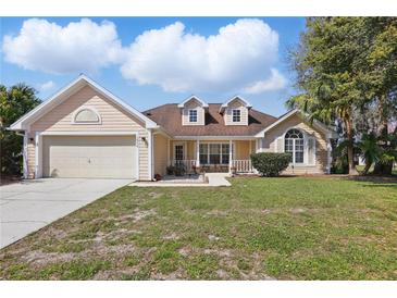 Charming single-Gathering home with a two-car garage and well-maintained front yard at 1916 Nicholas Pl, St Cloud, FL 34771