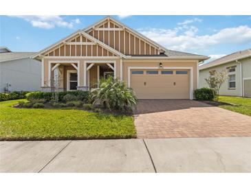 Charming one-story home featuring a two-car garage, paver driveway, and well-manicured landscaping at 2658 Meadowedge Loop, St Cloud, FL 34772