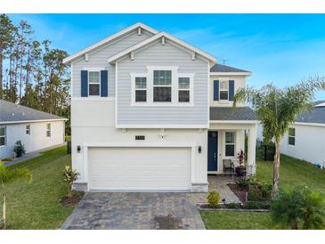 Beautiful two-story home featuring a two-car garage and lush landscaping for curb appeal at 2724 Camden Ln, Davenport, FL 33837