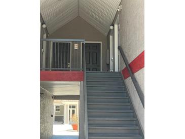 View of exterior stairs leading to a condo entrance at 3100 Parkway Blvd # 325, Kissimmee, FL 34747
