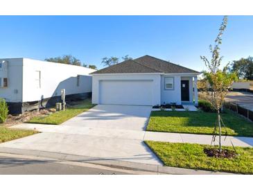 Charming single-Gathering home featuring a two-car garage and a well-manicured lawn in a modern design at 5539 Maddie Dr, Haines City, FL 33844