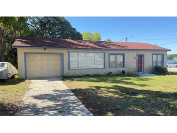 Charming single-story home featuring a front yard, driveway, and attached one-car garage at 100 Avenue K Ne, Winter Haven, FL 33881