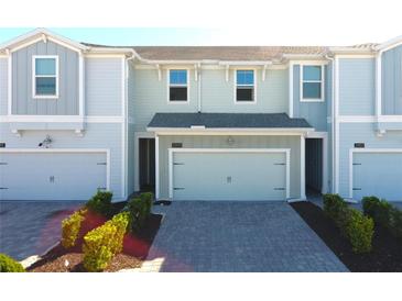 Charming townhome with a two-car garage and well-maintained landscaping at 2909 Theme St, Kissimmee, FL 34746