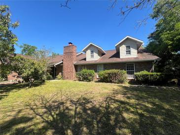 Charming two-story brick home with dormer windows and mature landscaping at 3725 Blossom St, Kissimmee, FL 34746