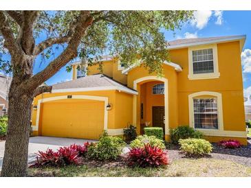 Charming home featuring a two-car garage and well-manicured landscaping at 917 Orange Cosmos Blvd, Davenport, FL 33837