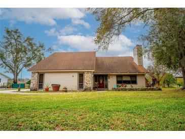Charming single-story home with a well-maintained lawn and a cozy front porch at 9916 Jackson Rd, Leesburg, FL 34788